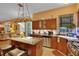 Well-lit kitchen featuring granite countertops, stainless steel appliances, and dark wood cabinetry at 2015 Long Branch Ln, Clearwater, FL 33760