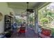 Inviting screened-in lanai with comfortable seating, ceiling fans, and views of the lush backyard at 2015 Long Branch Ln, Clearwater, FL 33760