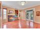 Living room showcasing fireplace, hardwood floors and French doors at 2015 Long Branch Ln, Clearwater, FL 33760