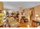 Open-concept living room with hardwood floors, seamless flow to kitchen at 2015 Long Branch Ln, Clearwater, FL 33760
