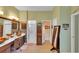 Serene Primary bathroom featuring dual sinks, a walk-in shower, and a neutral color palette with an opening to the toilet at 2015 Long Branch Ln, Clearwater, FL 33760