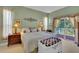 Light-filled main bedroom with balcony access, featuring neutral carpet and elegant decor with two bedside tables at 2015 Long Branch Ln, Clearwater, FL 33760