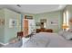 Relaxing main bedroom with green walls and a calm aesthetic, featuring carpet and white furnishings at 2015 Long Branch Ln, Clearwater, FL 33760