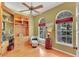 An office with built-in shelving, a comfortable chair, natural light, and custom touches provides a warm workspace at 2015 Long Branch Ln, Clearwater, FL 33760