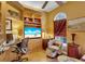 A sun-drenched office featuring custom shelving, a comfortable chair, and a large window offering a cozy work environment at 2015 Long Branch Ln, Clearwater, FL 33760