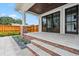 An inviting outdoor patio with stone flooring, brick accents, and black framed sliding glass doors at 2101 3Rd N Ave, St Petersburg, FL 33713