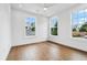 Bright bedroom features hardwood floors and windows with a view at 2101 3Rd N Ave, St Petersburg, FL 33713