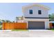 A two-story home with a garage is surrounded by a well-maintained fence and a tidy lawn at 2101 3Rd N Ave, St Petersburg, FL 33713