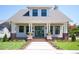 Charming two-story home with a welcoming front porch, lush lawn, and manicured landscaping at 2101 3Rd N Ave, St Petersburg, FL 33713