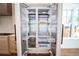 Kitchen with open refrigerator, white cabinets, and stainless steel appliances at 2101 3Rd N Ave, St Petersburg, FL 33713