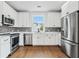 Modern kitchen with white cabinets, stainless steel appliances, and hardwood flooring at 2101 3Rd N Ave, St Petersburg, FL 33713