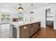 Open-concept kitchen with island seating, quartz countertops, and a view of the living area at 2101 3Rd N Ave, St Petersburg, FL 33713