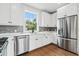 Modern kitchen with stainless steel appliances, quartz countertops, and stylish gray subway tile backsplash at 2101 3Rd N Ave, St Petersburg, FL 33713