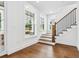 Staircase features wooden steps, iron railing, and natural light from large windows at 2101 3Rd N Ave, St Petersburg, FL 33713