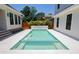 Clean, modern swimming pool with a tile border, nestled between pristine white homes and lush greenery at 2101 3Rd N Ave, St Petersburg, FL 33713