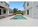 Backyard pool area with clean design and white tiled surroundings between two pristine white homes at 2101 3Rd N Ave, St Petersburg, FL 33713