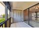 Enclosed outdoor balcony featuring white tile floors and access to a bedroom at 2131 Ridge S Rd # 3, Largo, FL 33778