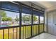 Relaxing enclosed balcony with white-tiled flooring and view of the neighborhood at 2131 Ridge S Rd # 3, Largo, FL 33778