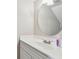 Bathroom vanity with white countertop and round mirror at 2131 Ridge S Rd # 3, Largo, FL 33778