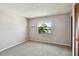 Bedroom with carpeted floors, neutral paint, and a window providing a view at 2131 Ridge S Rd # 3, Largo, FL 33778