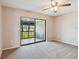 Bedroom with a ceiling fan, a sliding glass door to the screened-in porch, and neutral decor at 2131 Ridge S Rd # 3, Largo, FL 33778
