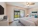 Bedroom with a ceiling fan, a sliding glass door to the screened-in porch, and neutral decor at 2131 Ridge S Rd # 3, Largo, FL 33778