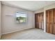 This carpeted bedroom features a window and built-in closet for ample storage at 2131 Ridge S Rd # 3, Largo, FL 33778