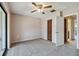 Bedroom with a ceiling fan, a closet, and a doorway to the hallway at 2131 Ridge S Rd # 3, Largo, FL 33778