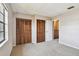 Bright bedroom with carpet, window and a closet with wooden doors at 2131 Ridge S Rd # 3, Largo, FL 33778
