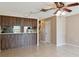 Open dining area featuring wood cabinets, neutral walls, and tile flooring at 2131 Ridge S Rd # 3, Largo, FL 33778