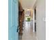 Inviting entryway featuring tile flooring, staircase with wood railing, and an open view into the living spaces at 2131 Ridge S Rd # 3, Largo, FL 33778