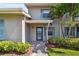 Inviting exterior showcasing landscaping, walkway, and charming blue shutters on a sunny day at 2131 Ridge S Rd # 3, Largo, FL 33778