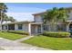 Inviting home featuring well-maintained landscaping, bright blue shutters, and mature palm trees in the front yard at 2131 Ridge S Rd # 3, Largo, FL 33778