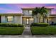 Charming home exterior with lush landscaping, blue shutters, and a welcoming walkway to the front door at 2131 Ridge S Rd # 3, Largo, FL 33778