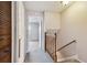 Hallway with access to rooms, featuring gray carpet and a wooden banister staircase at 2131 Ridge S Rd # 3, Largo, FL 33778