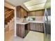 Kitchen with wood cabinets, tile backsplash, and stairs to the side at 2131 Ridge S Rd # 3, Largo, FL 33778
