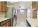 Bright kitchen featuring wood cabinets, stainless steel refrigerator, and tile floor at 2131 Ridge S Rd # 3, Largo, FL 33778