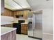 Modern kitchen featuring stainless steel refrigerator, black stove and wood-look cabinets at 2131 Ridge S Rd # 3, Largo, FL 33778