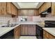 Kitchen features wood cabinets, stainless steel sink, and black oven at 2131 Ridge S Rd # 3, Largo, FL 33778