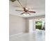 Bright, tiled living area featuring a ceiling fan and sliding glass doors leading to the outdoor space at 2131 Ridge S Rd # 3, Largo, FL 33778