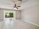 Spacious living area with tile flooring, a ceiling fan, and sliding glass doors that let in ample natural light at 2131 Ridge S Rd # 3, Largo, FL 33778