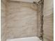 Close up of showerhead and custom tile backsplash in the shower and tub combo at 2131 Ridge S Rd # 3, Largo, FL 33778