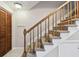 Carpeted staircase with wooden banister and railing leading to the upper level of the home at 2131 Ridge S Rd # 3, Largo, FL 33778