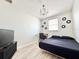 Bedroom featuring a queen bed, a work desk, and a modern chandelier at 2137 W Saint Louis St, Tampa, FL 33607
