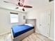 Bright bedroom with a ceiling fan, window, and ensuite door at 2137 W Saint Louis St, Tampa, FL 33607