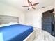 Bedroom featuring a ceiling fan, dresser, and comfortable decor at 2137 W Saint Louis St, Tampa, FL 33607