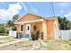 Charming single-story home featuring a stucco exterior, inviting front entrance, and well-maintained landscaping at 2137 W Saint Louis St, Tampa, FL 33607