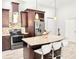 The kitchen features an island with seating, granite countertops, stainless appliances, and ample cabinet space at 2137 W Saint Louis St, Tampa, FL 33607