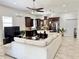 Open-concept living room with modern furnishings, a ceiling fan, and a view of the kitchen and stainless appliances at 2137 W Saint Louis St, Tampa, FL 33607