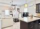 An open-concept living room with modern decor, lots of light, and adjoins the kitchen at 2137 W Saint Louis St, Tampa, FL 33607